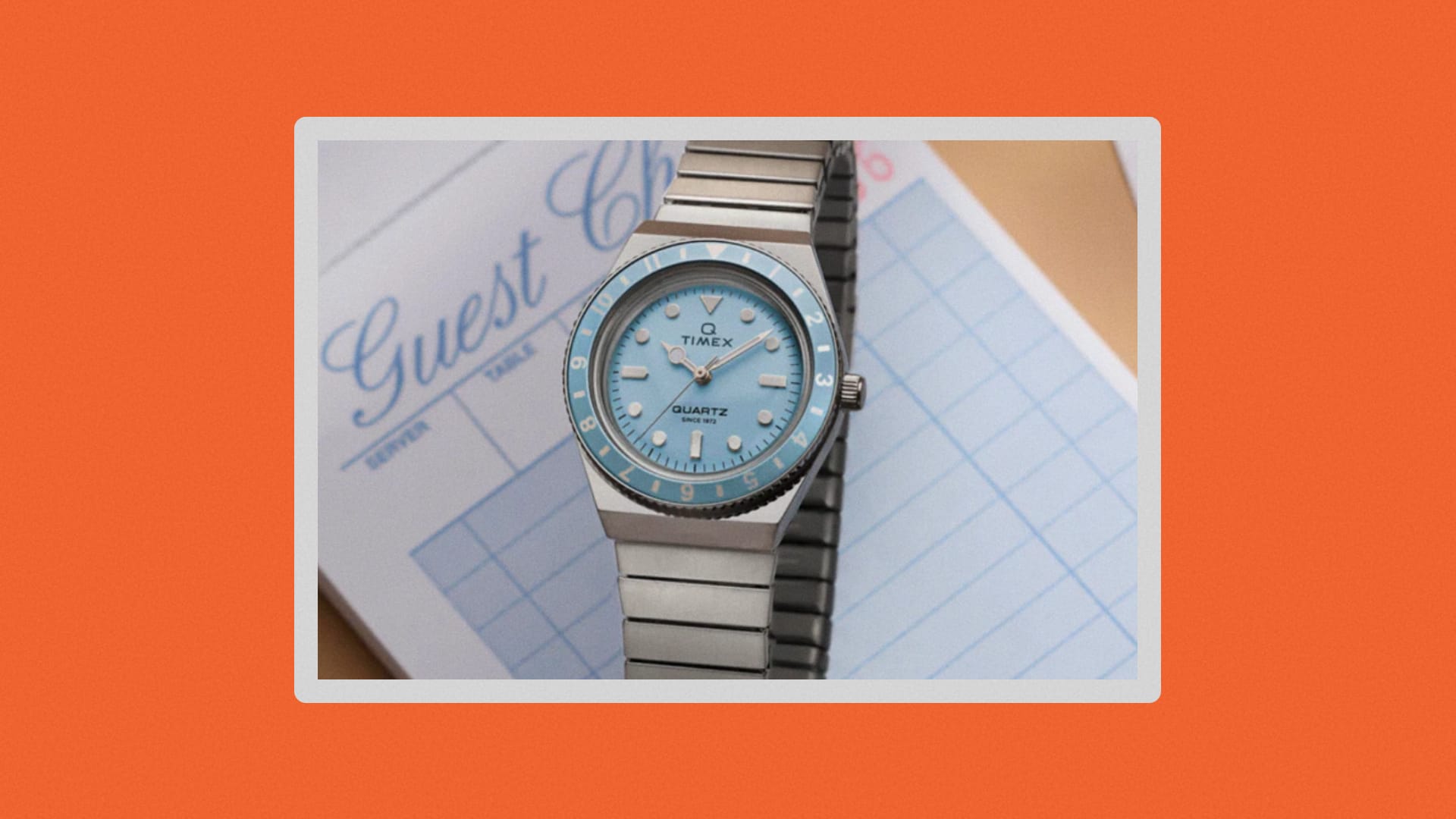 Close-up of the Q Timex mini with a blue watch face.