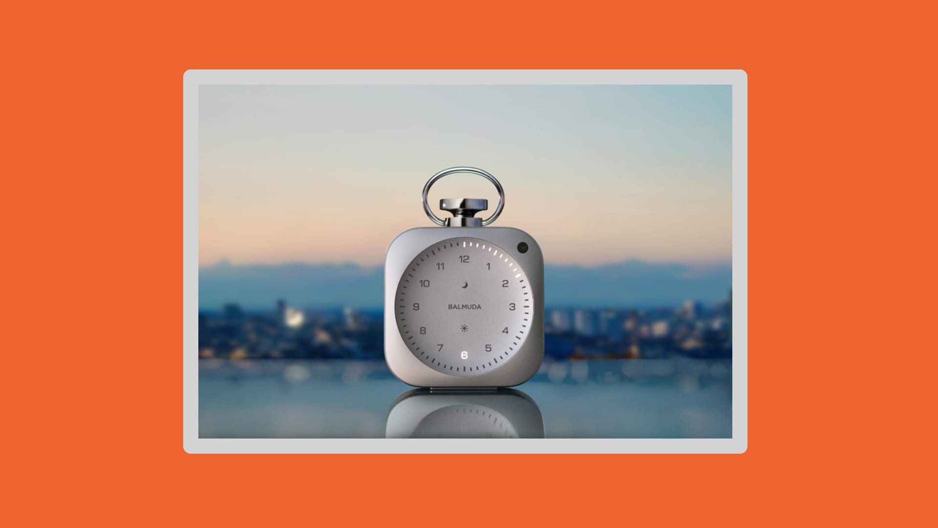 Metal clock with the sky in the background.