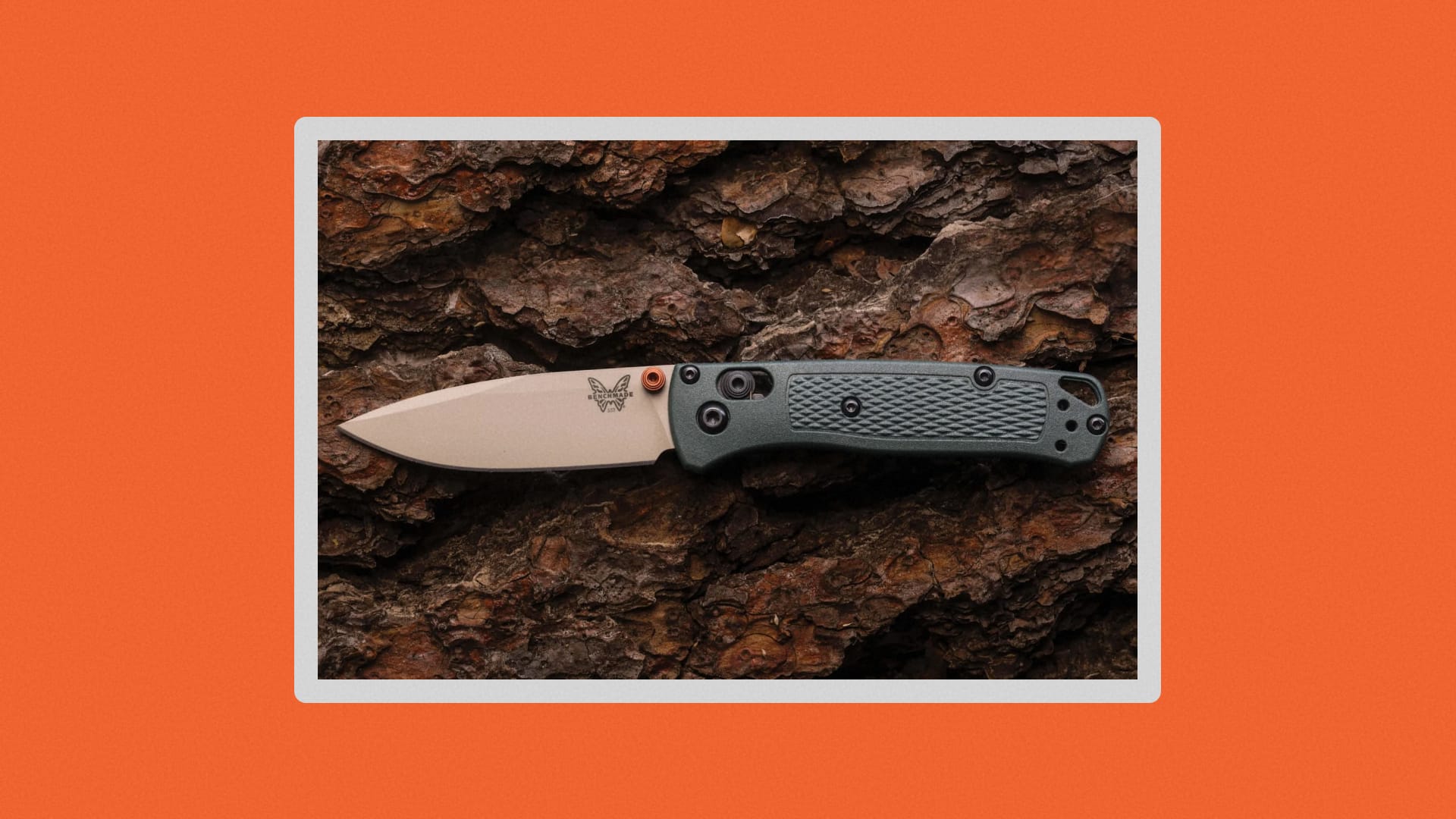 Close-up of the BugOut Mini in Taiga green on wood.